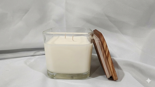 Square glass candle on a white background